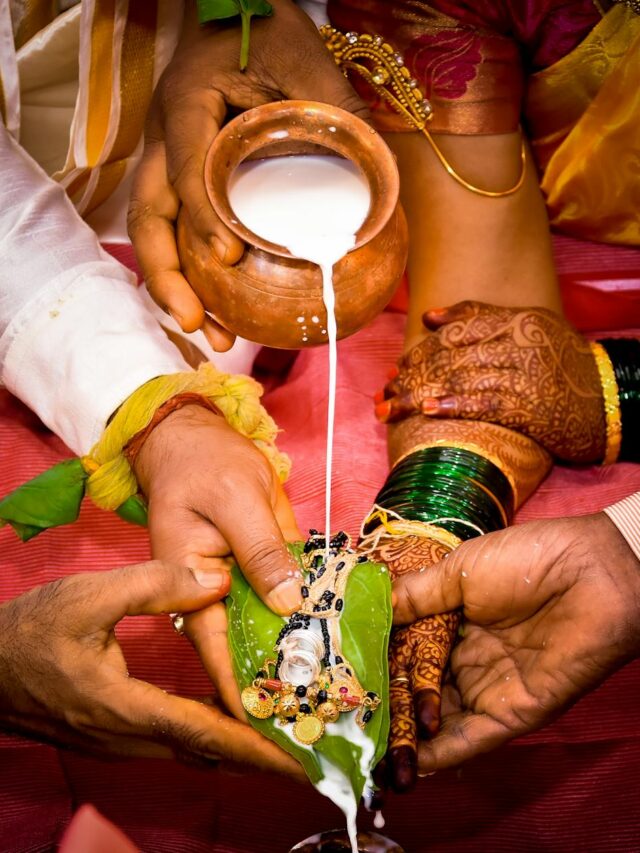 crop newlywed indian couple during traditional wedding ritual